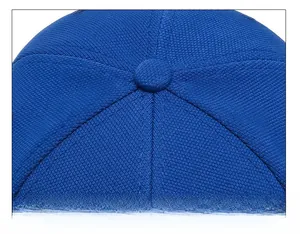 Detailed top view of navy blue baseball cap showing six-panel stitching and button
