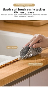 Macro shot of grey petal-shaped silicone brush bristles cleaning narrow sink gaps