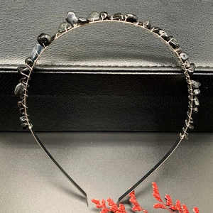 Detail of handmade black crystal stone headband with silver wire wrapping on metal