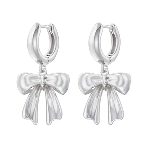 Detailed view of silver bow-shaped drop earrings with a polished metallic finish