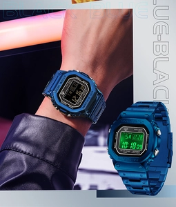 Close-up of square blue digital sport watches with luminous backlight and metallic finish