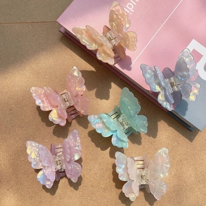 Detail of six colorful iridescent butterfly hair claws with translucent pearlescent finish