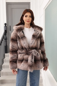 Detail of hooded faux fur coat in grey-brown gradient with waist belt and soft texture