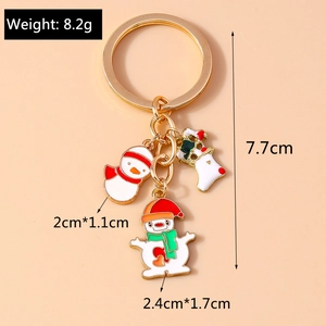 Detail view of gold Christmas keychain with enamel snowman and stocking charms and dimensions