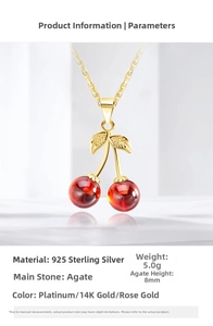 Detail of s925 silver cherry pendant with red agate stones and gold leaf plating