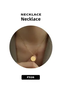 Detail of a 18k gold layered necklace with round Fu character pendant on a female model
