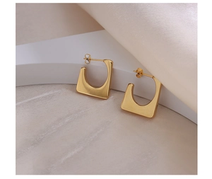 Macro detail of geometric square hoop earrings in 18k gold plated stainless steel
