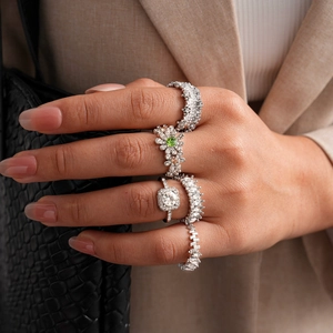Close-up of luxury 5-piece ring set with square zircon and floral designs on a hand