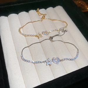 Detail view of adjustable star and heart charm bracelets with micro-paved cubic zirconia