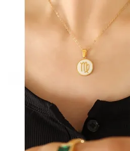 Detail of gold stainless steel necklace featuring a Virgo zodiac sign shell pendant