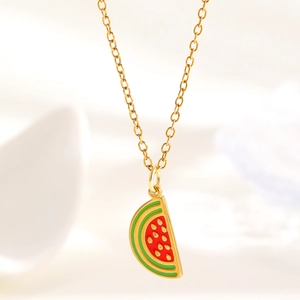 Detailed close-up of a watermelon slice pendant with green and red enamel and gold chain