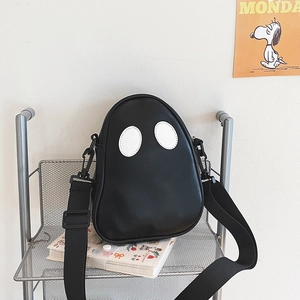 Detail of cartoon ghost crossbody bag showing PU leather texture and wide strap