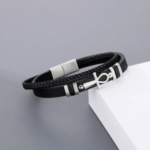 Detail of multi-layer black leather bracelet with silver Ankh cross and magnetic clasp