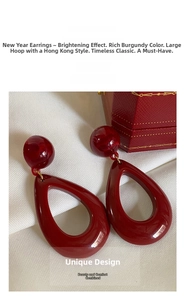 Macro detail of retro burgundy resin drop earrings with high-gloss finish