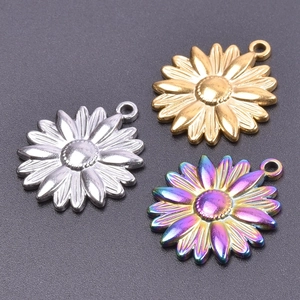 Macro shot of stainless steel sunflower pendants in silver, gold, and rainbow finishes