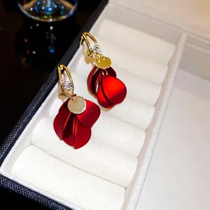 Elegant red matte petal tassel earrings with gold hooks and zircon studs in a white box