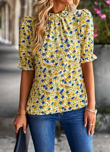 Détail du chemisier jaune à fleurs avec manches volantées et imprimé floral bleu