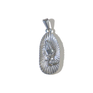 Macro shot of silver stainless steel oval pendant featuring praying hands and a cross