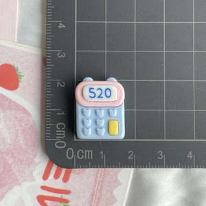 Detailed scale view of calculator resin charm with blue 520 text for DIY crafts