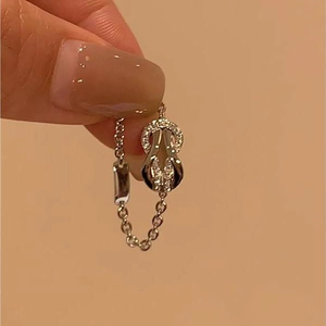 Silver chain ring featuring a horseshoe pendant with pavé set cubic zirconia stones