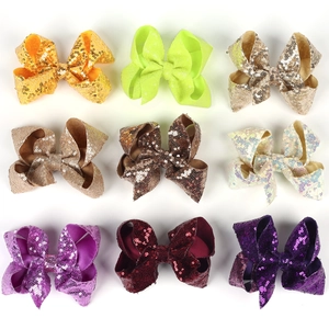 Set of nine 5-inch sequin hair bows for girls in multiple vibrant colors on white background