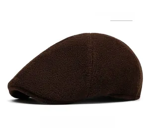 Close-up of the coffee brown wool knit texture and flat top design of the beret cap