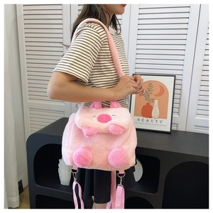 Pink plush cartoon capybara bag shown on a model with adjustable straps and soft texture