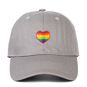 Detailed close-up of rainbow heart embroidery on light gray cotton baseball cap