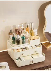 Detail view of cream makeup organizer with gold handles and dual drawers on vanity
