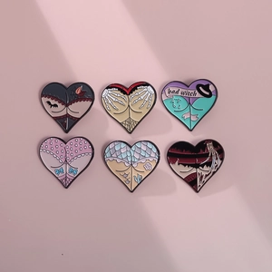 Set of six heart-shaped enamel pins with gothic, mermaid and witch comic designs