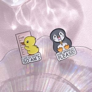 Cute enamel animal pins set featuring a duck and penguin with funny quotes on glass tray