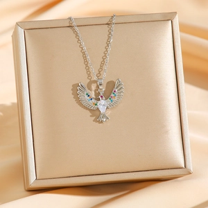 Luxurious silver necklace with colorful crystal phoenix bird pendant on silk display