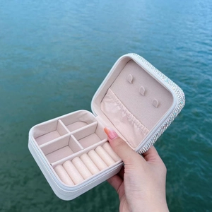 Detail of white crystal jewelry box with pink velvet interior and ring slots