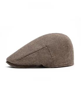 Side view of men's vintage herringbone flat cap with wool blend tweed texture