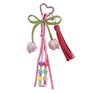 Elegant bohemian woven tulip flower keychain with pink tassel and heart-shaped carabiner hook