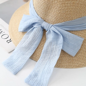 Straw sun hat with light blue chiffon bow for beach vacations and sun protection