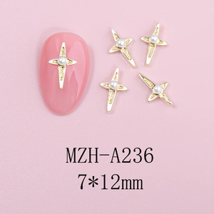 Macro shot of 7x12mm gold cross nail art charms with pearls and starburst design