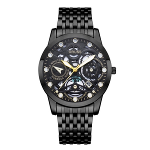 Detailed close-up of a hollow skeleton dial with gold hands and black metal strap