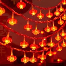 Close-up of festive red lantern LED string lights with warm glow for holiday decoration
