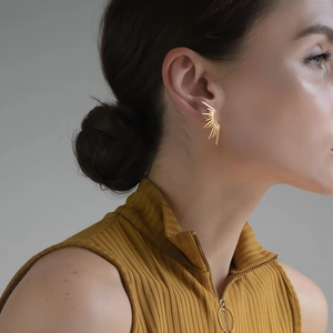 Elegant 18K gold-plated stainless steel sunburst earrings worn on a female model