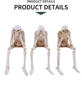 Three skeleton figurines showing hear, see, and speak no evil with gold joint accents