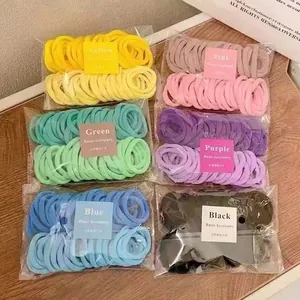 Detail view of 6-color high elasticity hair tie sets in clear packaging on wooden surface