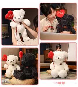 Close-up of teddy bear plush holding a heart-shaped balloon with happily met embroidery