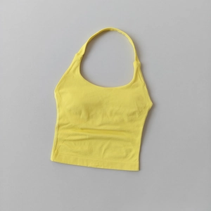 Detail of yellow halter yoga vest featuring breathable wavy knit texture and U-neck