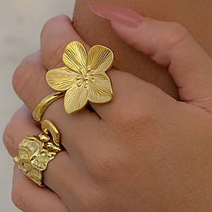 Gold stainless steel ring set with flower design and hammered texture on hand