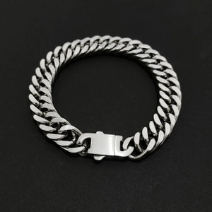 Close-up of polished silver stainless steel Cuban link bracelet with large clasp