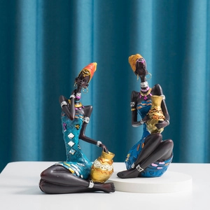 Detailed resin African women statues in blue and cyan robes with golden jar accents