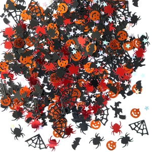 Halloween party confetti with pumpkin, spider, bat, and witch shapes in vibrant colors