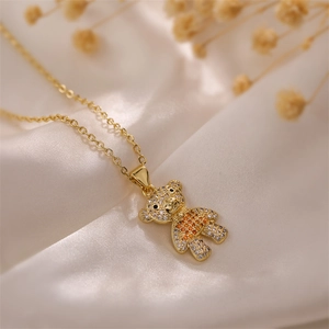 Detail of bear pendant necklace with gradient rhinestones on silk and dried flowers