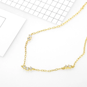 Minimalist 18k gold plated necklace with three small clear zircon stones on a fine chain